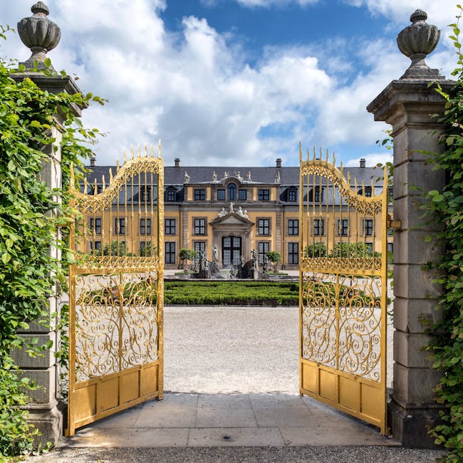 Golden gates open to the majestic Herrenhausen Palace in Hannover, Germany.